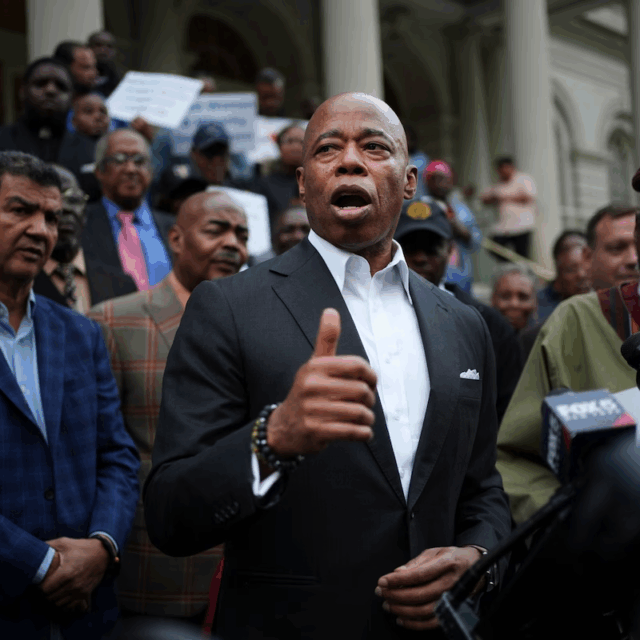New York City Mayor Eric Adams speaks while surrounded by faith leaders and other supporters during a rally and prayer vigil on the steps of City Hall in New York, on Tuesday, October 1, 2024.