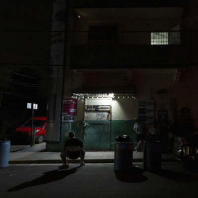 A lamp powered by a generator illuminates a sidewalk during a blackout in San Juan, Puerto Rico, after sunset Tuesday, Dec. 31, 2024. (AP Photo/Alejandro Granadillo)