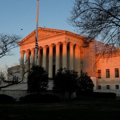 Sunset rays hit the supreme court building.