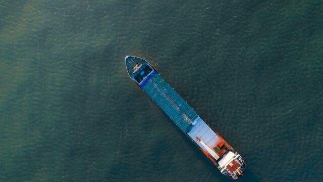 A cargo ship cruises on a canal.