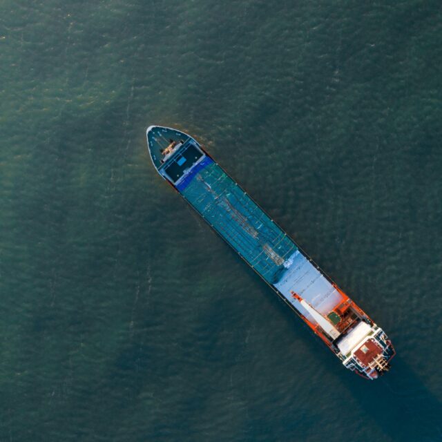 A cargo ship cruises on a canal.