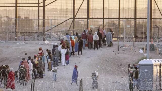 Migrants wait to be processed by U.S. Border Patrol officers at the U.S.-Mexico border in El Paso, Texas, on May 12, 2023.