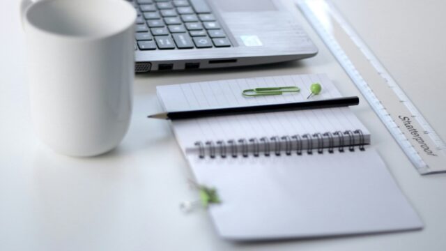 Office supplies placed on a desk (via Unsplash).