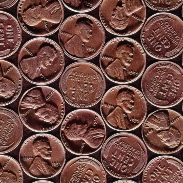 Pennies lined up in a grid formation fill the screen.