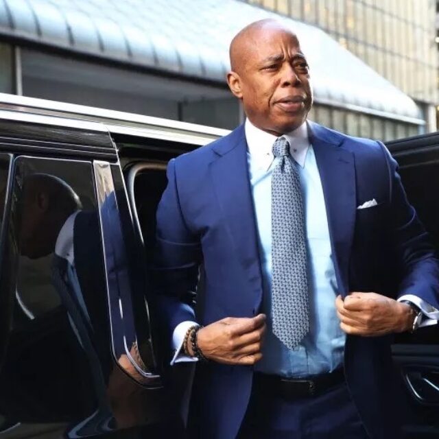 NYC mayor Eric Adams steps out of vehicle.