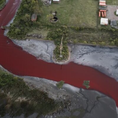The Sarandí river in Argentina dyed red from pollutant.