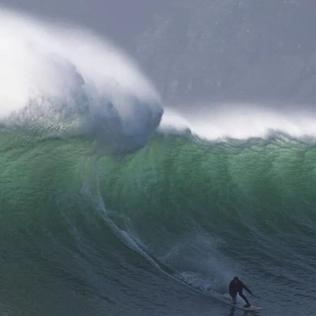 A surfer catches a wave at Sunset, an offshore surfing spot close to Hout Bay, that produces some of South Africa's biggest waves in Capetown. 2022