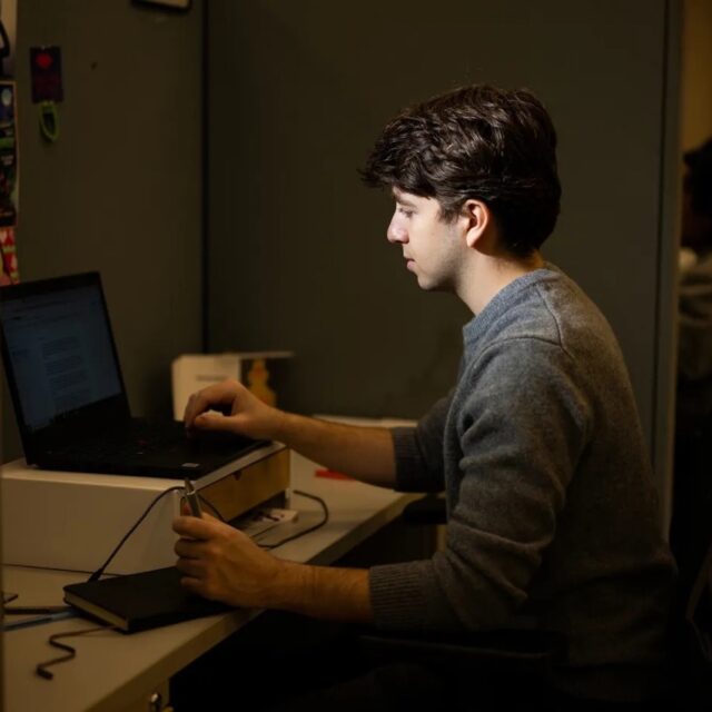 Eli Curwin sits at his laptop
