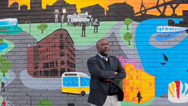 Rashaun Martin, managing director of recruitment, cultivation, and diversity programs for Boston Public Schools, stood in Nubian Square in front of “Youth Speaks,” a 2024 mural by the Boston Student Advisory Council.Pat Greenhouse/Globe Staff
