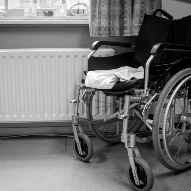 Empty wheelchair in a hospital room