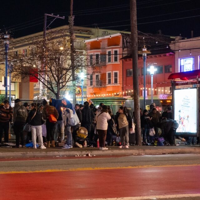 Crowds mill around the entrance to the 16th Street and Mission BART station. | Source:Andy Omvik for The Standard