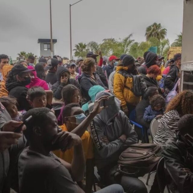 A stock image of migrants gathering for a rally at the U.S.-Mexico border. Aimee Melo/dpa via AP