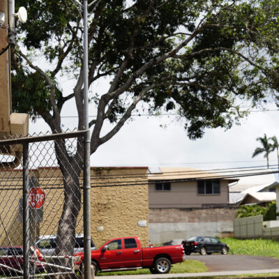 Residential apartments and homes sit across Kilani Avenue from a security camera at the George F. Wright Wahiawā District Park swimming pool Friday, June 20, 2025, in Wahiawā. (Kevin Fujii/Civil Beat/2025)
