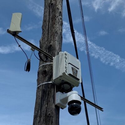 A utility pole in Cleveland with a camera attatched.