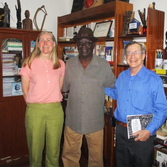 Political scientists Martha Johnson, left, and William Miles, right, pictured with West African Research Center Director Ousmane Sene.
