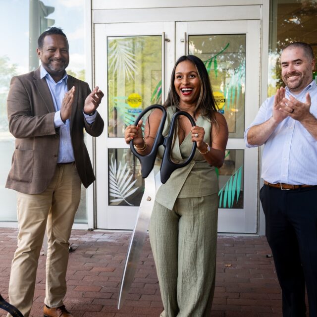 ortheastern graduate Ammy Lowney, center, celebrates opening a new Juicygreens shop at Northeastern’s International Village with a ribbon cutting.