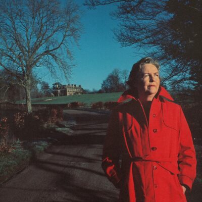 Kaplan standing in front of a house