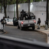 22 February 2026, Mexico, Mexiko-Stadt: Members of the special units of the National Guard and the Secretaria de Seguridad Ciudadana stand guard in front of the Fiscalia General de la Republica, where the investigation into the operation in which Nemesio Oseguera Cervantes, alias 
