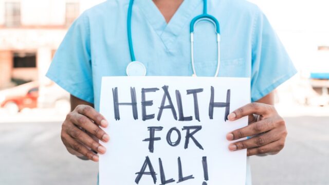 portrait of an unrecognizable African American man holding a banner that says 
