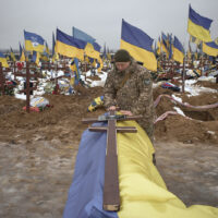 Funeral ceremonies take place during the burial of several Ukrainian soldiers at Military Cemetery No. 18 in Kharkiv, as relatives, fellow servicemen and mourners gather to pay their last respects amid Russia's ongoing invasion of Ukraine, on January 8, 2026 in Kharkiv, Ukraine. (Photo by Kostiantyn Liberov/Libkos/Getty Images).