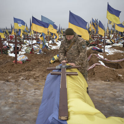 Funeral ceremonies take place during the burial of several Ukrainian soldiers at Military Cemetery No. 18 in Kharkiv, as relatives, fellow servicemen and mourners gather to pay their last respects amid Russia's ongoing invasion of Ukraine, on January 8, 2026 in Kharkiv, Ukraine. (Photo by Kostiantyn Liberov/Libkos/Getty Images).