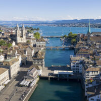 ZURICH, SWITZERLAND - JULY 12: An aerial drone view of the city centre of Zurich, Limmat River, Lake Zurich, and the Grossmuenster Church stand during the coronavirus pandemic on July 12, 2020 in Zurich, Switzerland. Switzerland has largely lifted most of its coronavirus lockdown measures and has so far registered approximately 33,000 infections. (Photo by Christian Ender/Getty Images).