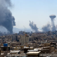 Plumes of smoke rise following reported explosions in Tehran on March 1, 2026, after Iran's supreme leader, Ayatollah Ali Khamenei, was killed a day earlier in a large U.S. and Israeli attack, prompting a new wave of retaliatory missile strikes from Iran. (Photo by Mahsa / Middle East Images / AFP via Getty Images)