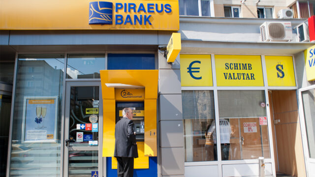 TIMISOARA, ROMANIA - APRIL 14: A man withdraw some cash from the Piraeus Bank on April 14, 2013 in Timisoara, Romania. Romania has abandoned a target deadline of 2015 to switch to the single European currency and will now submit to the European Commission a programme on progress towards the adoption of the Euro, which for the first time will not have a target date. (Photo by Marco Secchi/Getty Images)