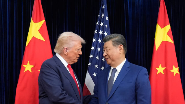 FILE - President Donald Trump, left, and Chinese President Xi Jinping, right, shake hands before their meeting at Gimhae International Airport in Busan, South Korea, Oct. 30, 2025. (AP Photo/Mark Schiefelbein, File)