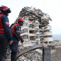 Rescue workers search through the rubble after an earthquake in La Guaira, Venezuela, Thursday, June 25, 2026. (AP Photo/Pedro Mattey)