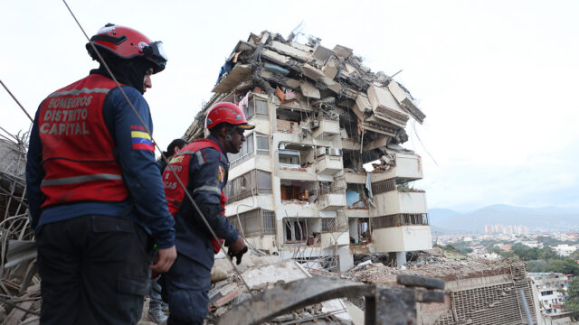Rescue workers search through the rubble after an earthquake in La Guaira, Venezuela, Thursday, June 25, 2026. (AP Photo/Pedro Mattey)