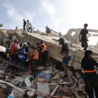 LA GUAIRA, VENEZUELA - JUNE 25: People and rescuers search for victims amid debris of demolished buildings as rescue efforts continue after a magnitude 7.2 earthquake struck Venezuela and other regions in the Caribbean on June 25, 2026 in La Guaira, Venezuela. According to the U.S. Geological Survey (USGS), the main earthquake was followed by a 7.5-magnitude aftershock less than a minute later. The number of victims increased to 188 and over a 1500 injured. (Photo by Jesus Vargas/Getty Images)