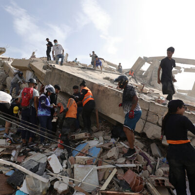 LA GUAIRA, VENEZUELA - JUNE 25: People and rescuers search for victims amid debris of demolished buildings as rescue efforts continue after a magnitude 7.2 earthquake struck Venezuela and other regions in the Caribbean on June 25, 2026 in La Guaira, Venezuela. According to the U.S. Geological Survey (USGS), the main earthquake was followed by a 7.5-magnitude aftershock less than a minute later. The number of victims increased to 188 and over a 1500 injured. (Photo by Jesus Vargas/Getty Images)