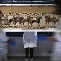 Workers and volunteers prepare to pack the Bayeux tapestry to transfer to the British Museum, at the Bayeux Tapestry Museum, in Bayeux, northwestern France, Thursday, Sept. 18, 2025. (Lou Benoist, Pool via AP)