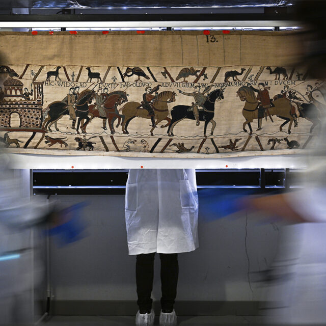 Workers and volunteers prepare to pack the Bayeux tapestry to transfer to the British Museum, at the Bayeux Tapestry Museum, in Bayeux, northwestern France, Thursday, Sept. 18, 2025. (Lou Benoist, Pool via AP)