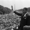US civil rights leader Martin Luther King (C) waves to supporters on August 28, 1963 on the Mall in Washington DC (Washington Monument in background) during the 