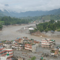 A damaged section of a highway in Nuwakot, central Nepal, is seen on August 27, 2026, following a glacial lake outburst in Tibet. Rescue teams collect bodies, while residents displaced by the flooding shelter in elevated areas. The flooding has damaged roads and disrupted transportation in the region. (Photo by Sanjit Pariyar/NurPhoto via AP)