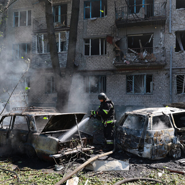 Rescue workers try to put out a fire of a residential building and cars burning after a Russian air guided bomb strike in Zaporizhzhia, Ukraine, Monday, Aug. 10, 2026. (AP Photo/Kateryna Klochko)