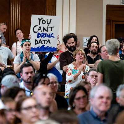 Hundreds attend a Town of Tonawanda Planning Board meeting in Kenmore, N.Y. Wednesday, June 3, 2026, as they expressed vocal and at times boisterous opposition about a proposed data center on the site of the now closed Tonawanda Coke facility. Attendees spoke of the environmental damage created by the former coke plant, and a legacy of pollution endured by people in Western New York, rebuking the project as a return to problems created by past industries. (Photo by Craig Ruttle/Sipa USA)(Sipa via AP Images)