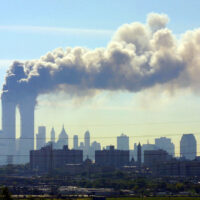 As seen from the New Jersey Turnpike near Kearny, N.J., smoke billows from the twin towers of the World Trade Center in New York after airplanes crashed into both towers Tuesday, Sept.11, 2001. (AP Photo/Gene Boyars)
