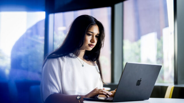 10/20/26 - BOSTON, MA. - Kayla Ruggiero, who studies Political science and international affairs, works on a laptop inside the EXP building on Oct. 20, 2026. Ruggiero recently completed a co-op at the Scottish Parliament. Photo by Matthew Modoono/Northeastern University