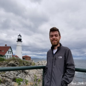 kenny standing in front of a lighthouse